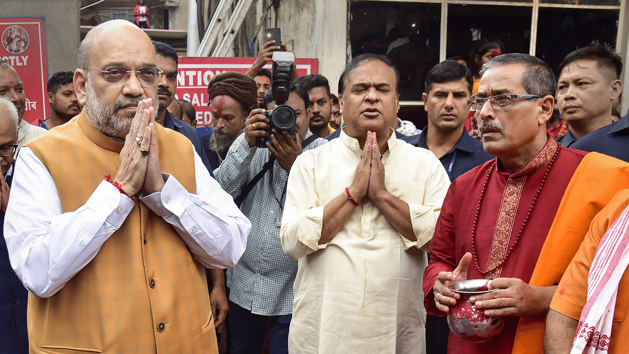 Union Home Minister Amit Shah with Assam Chief Minister Himanta Biswa Sarma offers prayers during a visit to the Kamkhya temple, in Guwahati. Credit: PTI Photo