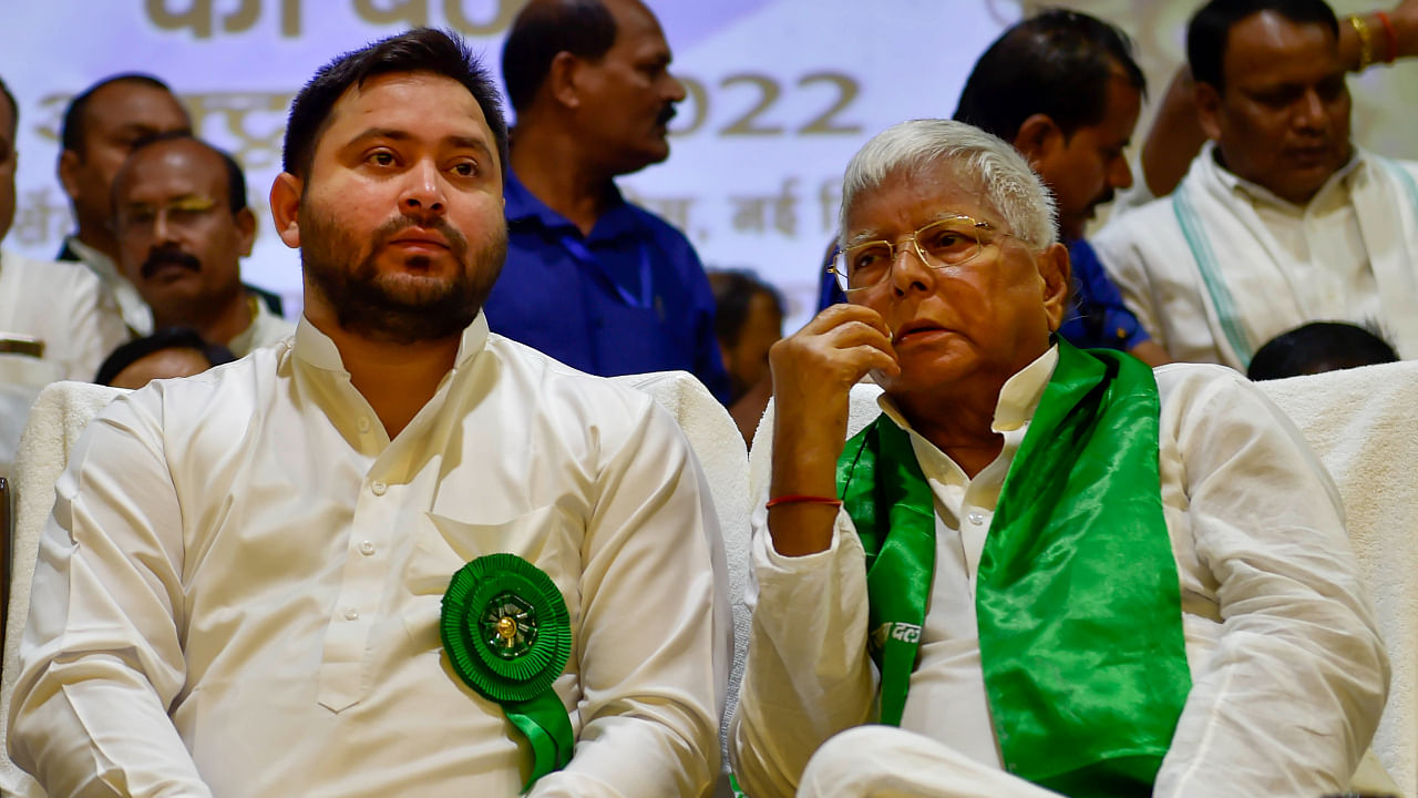RJD chief Lalu Prasad with party leader Tejashwi Yadav during the party's national executive meeting, in New Delhi, Sunday, Oct. 9, 2022. Credit: PTI Photo