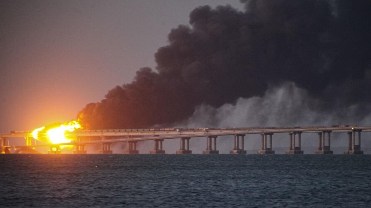 Flame and smoke rise from Crimean Bridge connecting Russian mainland and Crimean peninsula over the Kerch Strait, in Kerch, Crimea, Saturday, Oct. 8, 2022. Credit: AP Photo