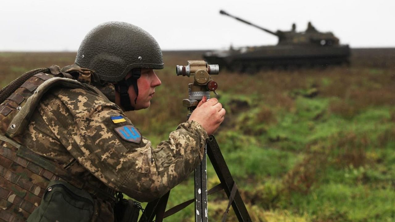 A Ukrainian soldier aims before a 2S1 Gvozdika tank fires a shell on the front line in Donetsk region. Credit: AFP Photo