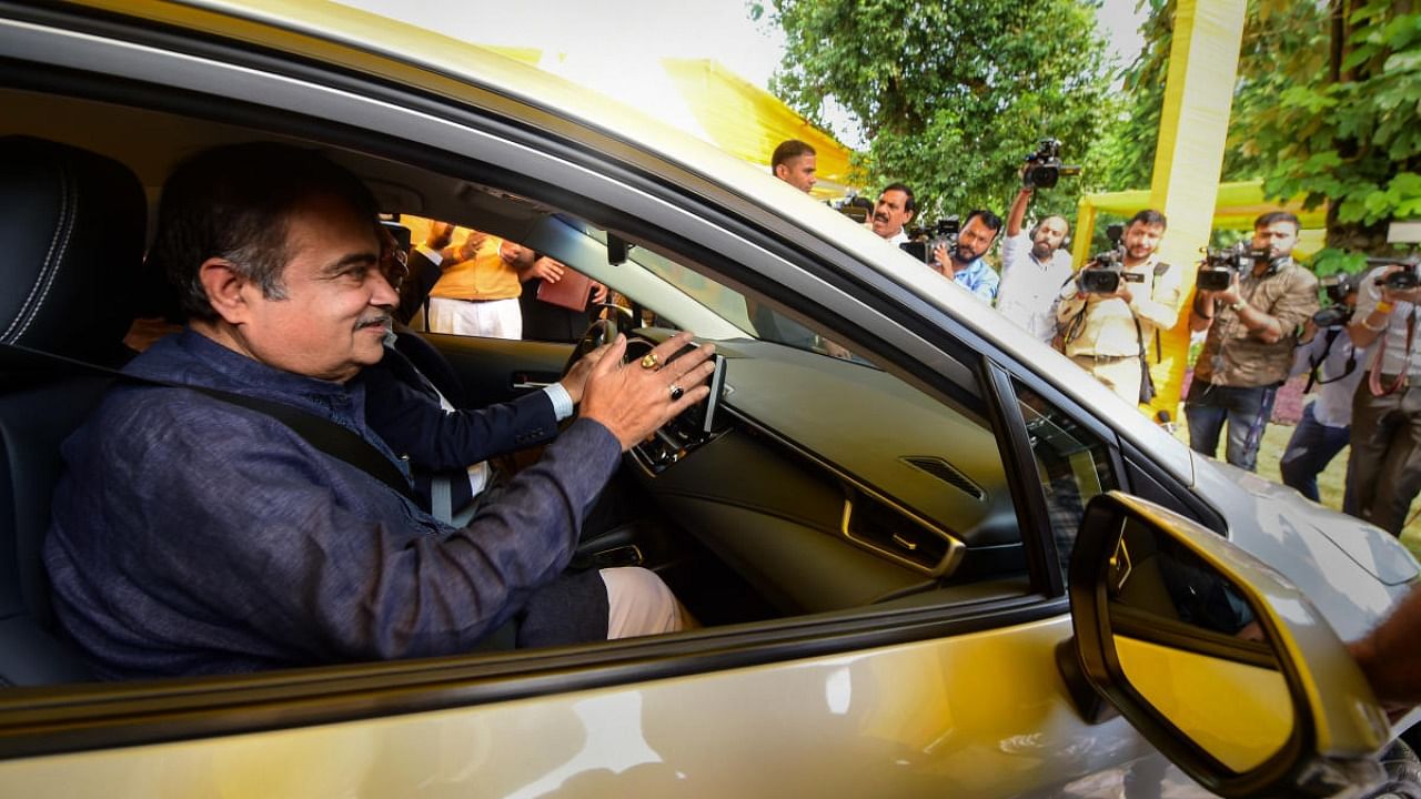 Nitin Gadkari rides a car at the launch of Toyota’s first-of-its-kind pilot project on Flexi-Fuel Strong Hybrid Electric Vehicles. Credit: PTI Photo