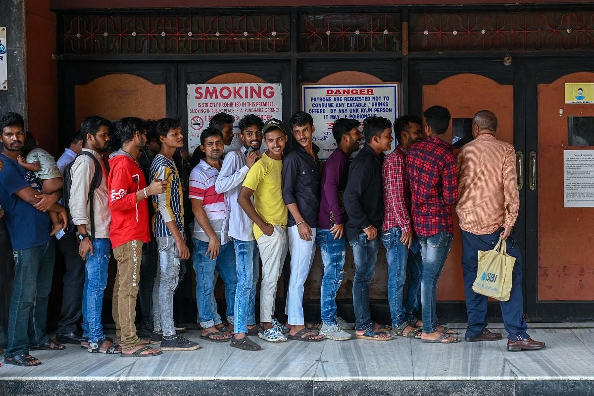 Moviegoers queue up to enter the G7 multiplex in Mumbai. Credit: AFP Photo