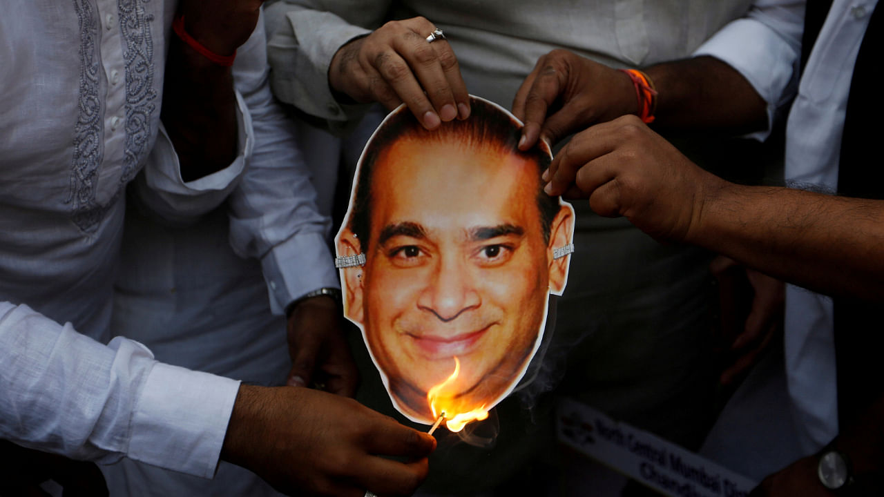 Activists burn a cut-out with an image of Nirav Modi. Credit: Reuters File Photo