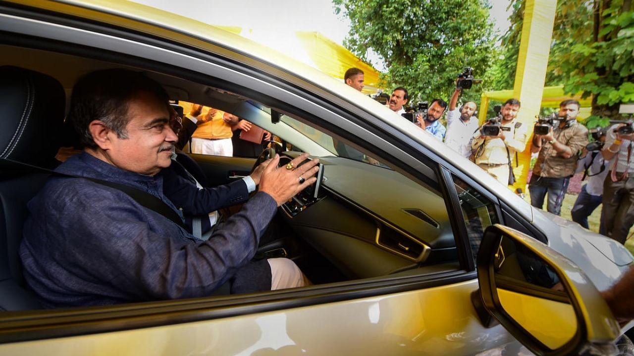 Union Minister for Road Transport & Highways Nitin Gadkari rides a car at the launch of Toyota’s first-of-its-kind pilot project on Flexi-Fuel Strong Hybrid Electric Vehicles. Credit: PTI Photo