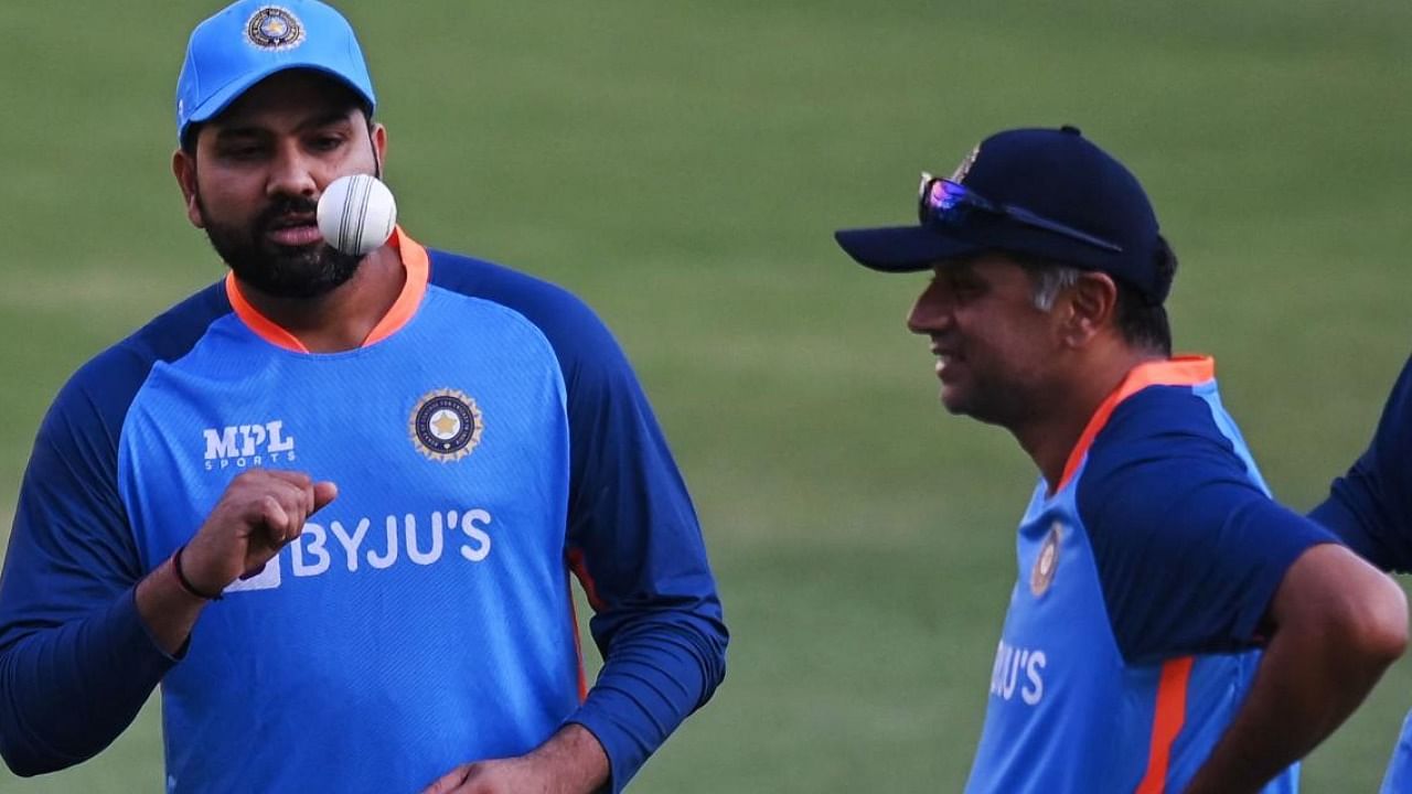Indian skipper Rohit Sharma (L) with coach Rahul Dravid at a practice session. Credit: AFP File photo