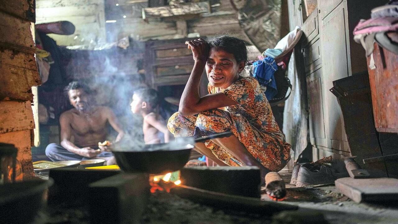  A woman sits by the fireplace at meal time in a shanty in Colombo, Sri Lanka. Credit: AP/PTI Photo