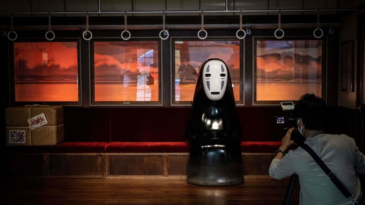 A member of the media takes video of an exhibit at Ghibli's Grand Warehouse during a media tour of the new Ghibli Park in Nagakute. Credit: AFP Photo