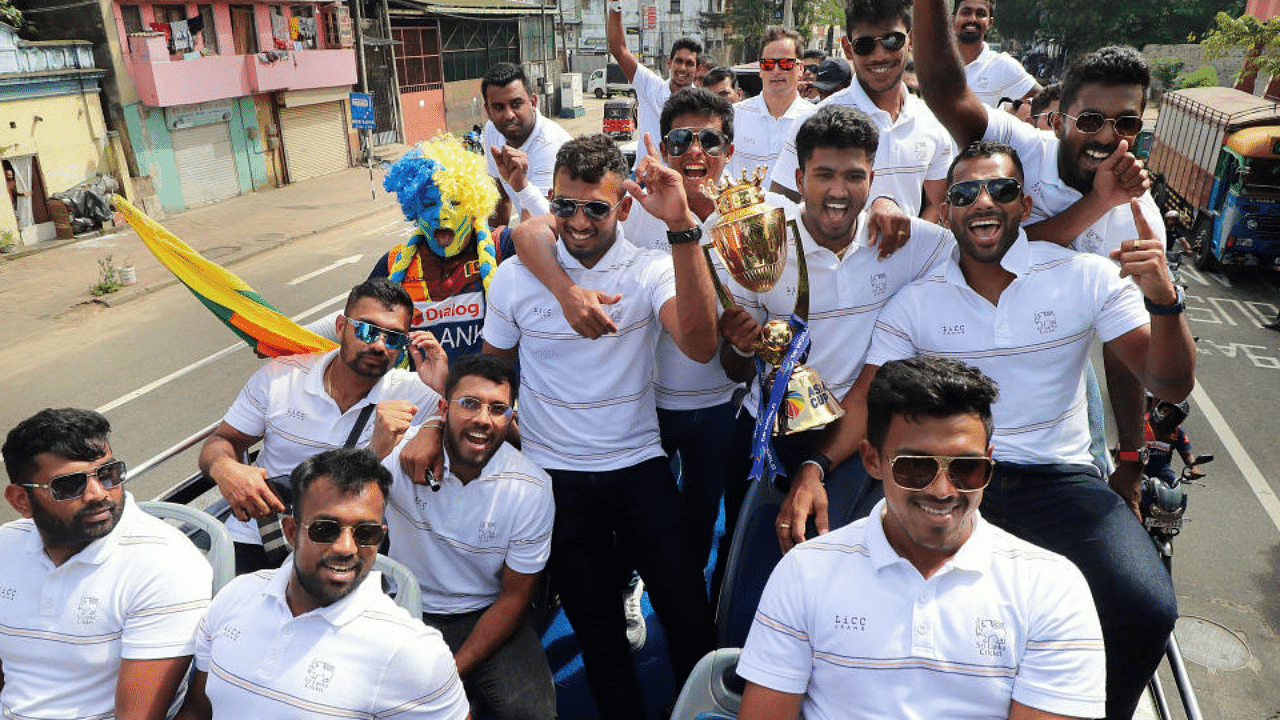 Sri Lanka's cricket team players cheer as they are welcomed upon their arrival after the Asia Cup win. Credit: PTI Photo