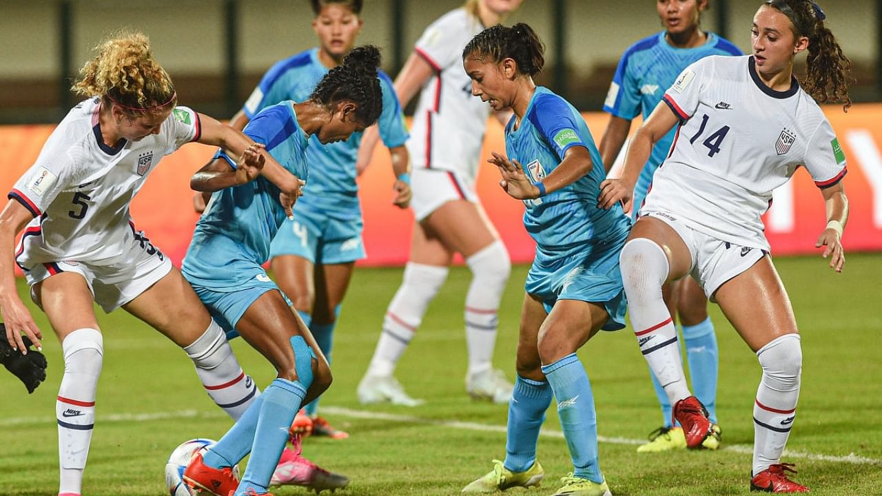 Indian (blue) and USA players in action during their match at FIFA U-17 Women's World Cup 2022 at Kalinga Stadium, in Bhubaneswar, Oct. 11, Tuesday, 2022. Credit: PTI Photo