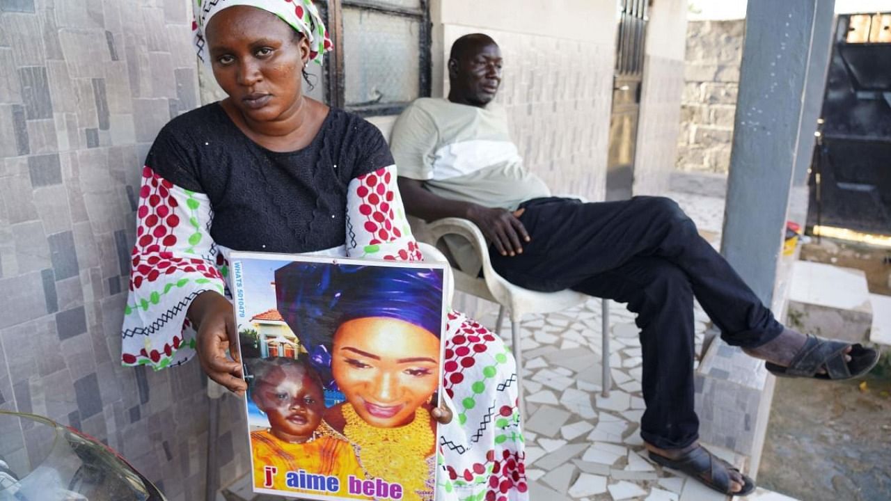 Mariama Kuyateh, holds up a picture of her late son Musa who died from acute kidney failure, in Banjul on October 10. Credit: AFP Photo