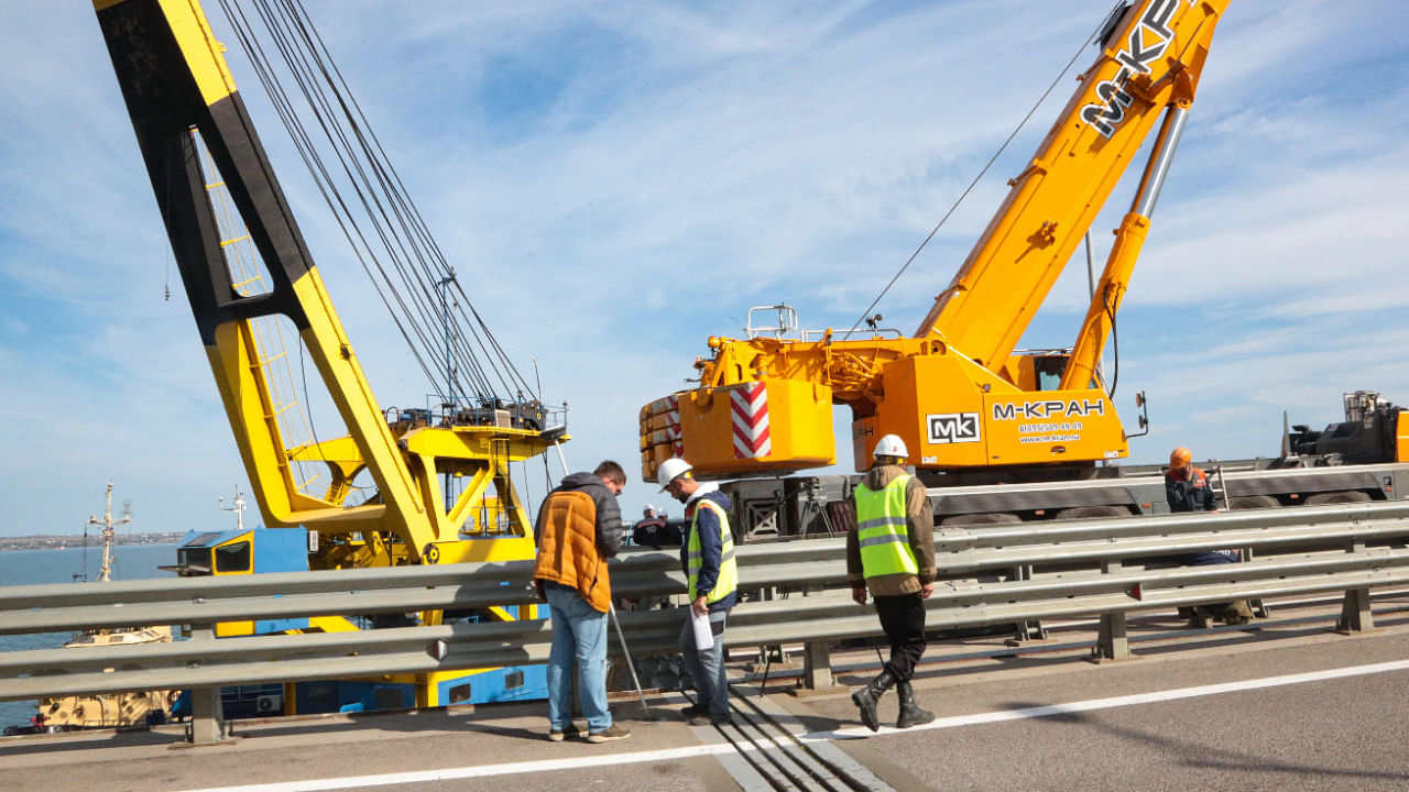 Workers restoring damaged parts of the Kerch Bridge that links Crimea to Russia, which was hit by a blast on October 8. Credit: AFP Photo