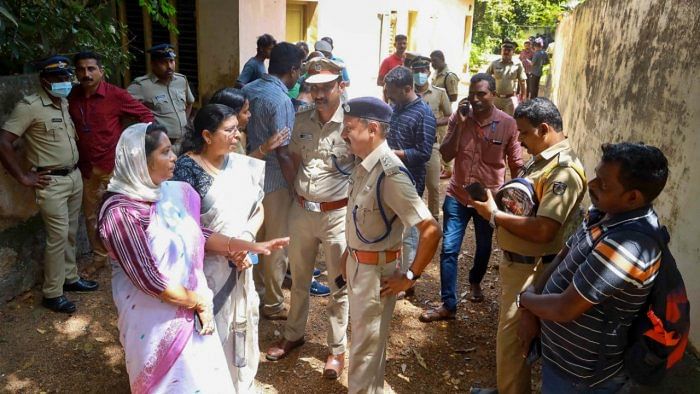Police and locals at the place where two women were allegedly murdered and buried in a case of black magic and human sacrifice at Elanthoor in Pathanamthitta district of Kerala. Credit: PTI Photo