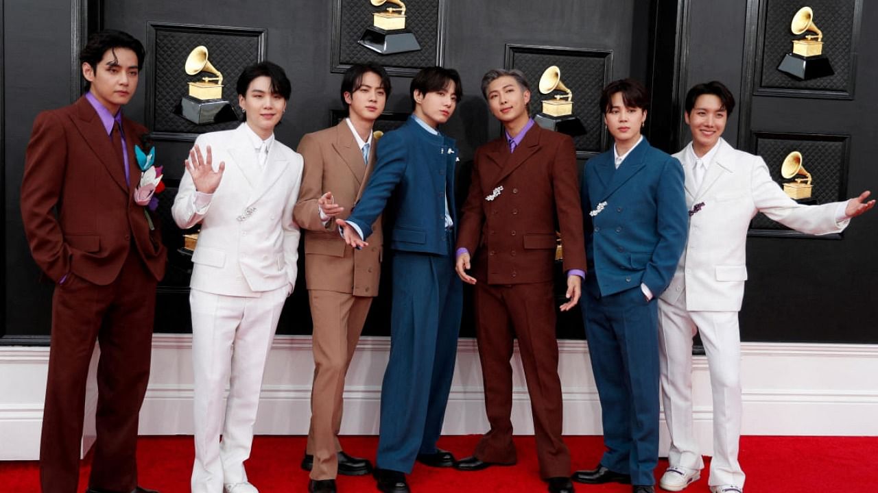 BTS members pose for the shutterbugs at the 64th Grammy awards in US. Credit: Reuters File Photo