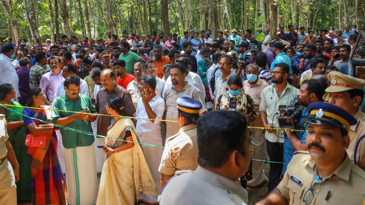 Police and locals at the place where two women were allegedly murdered and buried in a horrific case of black magic and human sacrifice at Elanthoor in Pathanamthitta district of Kerala. Credit: PTI File Photo