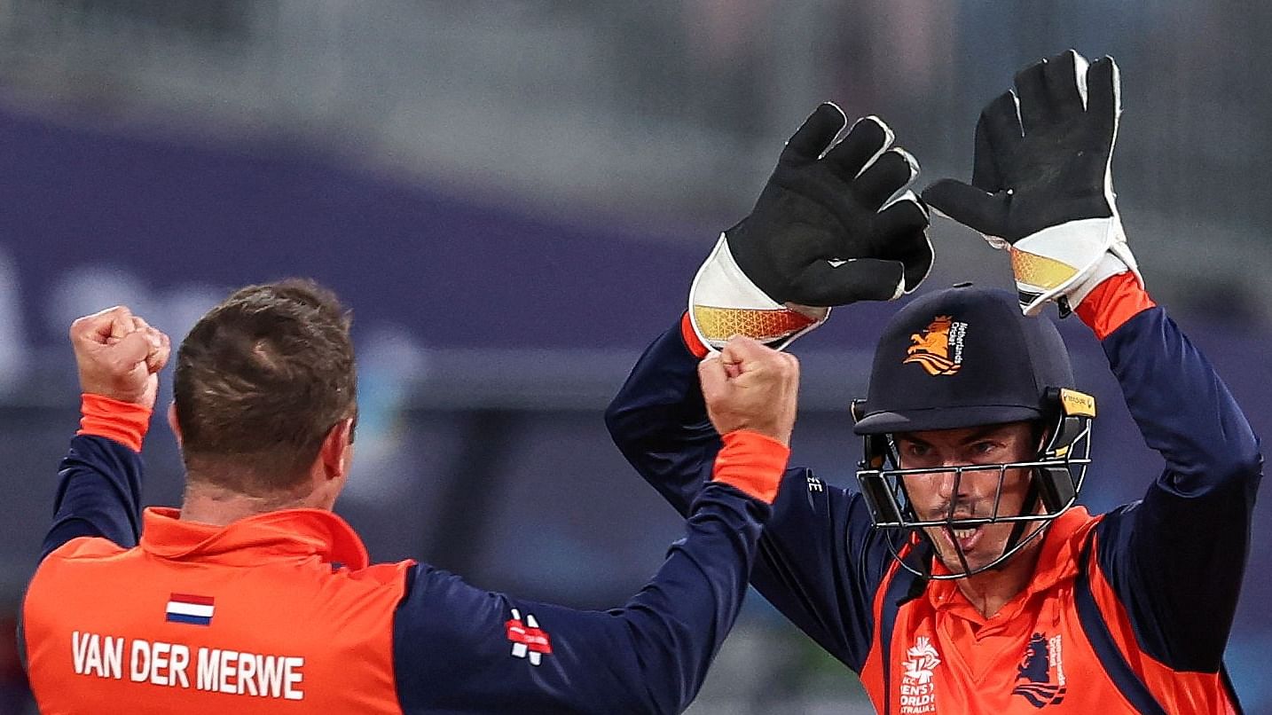 Netherlands' Roelof van der Merwe and Scott Edwards celebrate the wicket of UAE's Chirag Suri during the Australia 2022 Twenty20 World Cup. Credit: AFP Photo