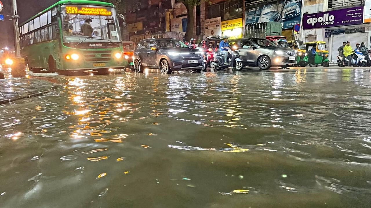The busy JC Road in Bengaluru is waterlogged following heavy rain on Saturday night. Credit: DH Photo/Ranju P
