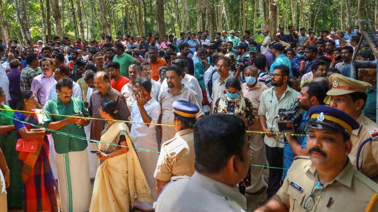 Police and locals at the place where two women were allegedly murdered and buried in a horrific case of black magic and human sacrifice at Elanthoor in Pathanamthitta. Credit: PTI Photo