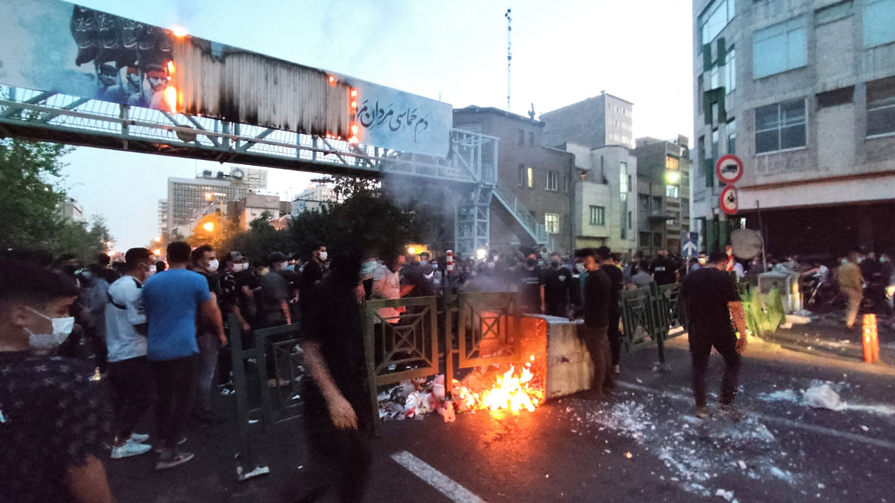 People light a fire during a protest over the death of Mahsa Amini, a woman who died after being arrested by the Islamic republic's "morality police", in Tehran, Iran September 21, 2022. Credit: Reuters via WANA