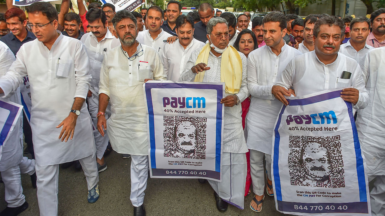 Karnataka Congress leaders hold posters with QR code and the phrase 'PayCM', during a protest against the state government on the issue of alleged corruption, in Bengaluru, Friday, Sept. 23, 2022. Credit: PTI File Photo