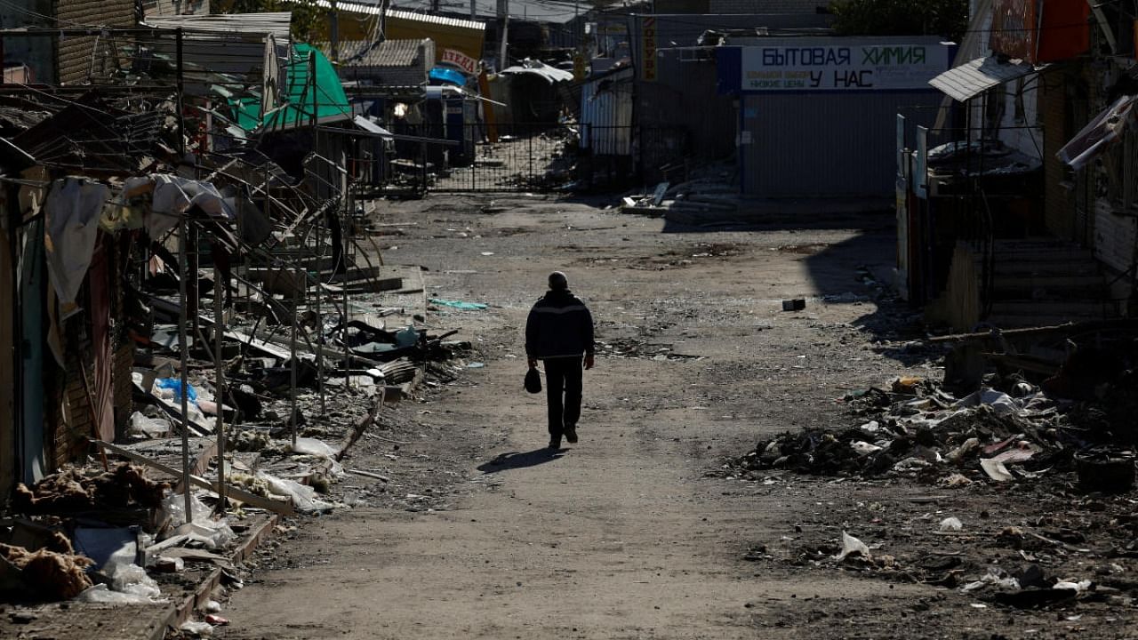 A man walks through a shopping street destroyed by Russian strikes, amid Russia's attack on Ukraine, in the recently retaken town of Kupiansk, Ukraine. Credit: Reuters Photo