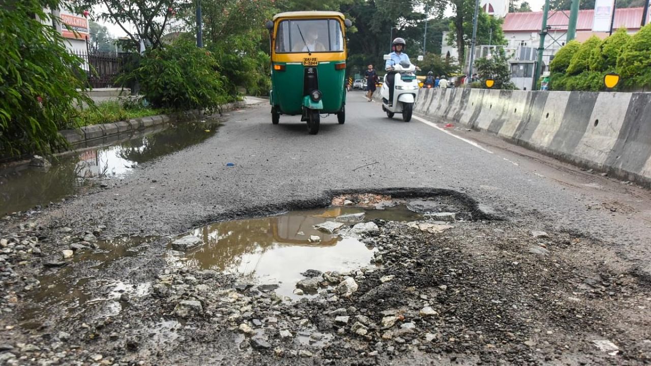 A crater-like pothole on Magrath Road. Credit: DH Photo