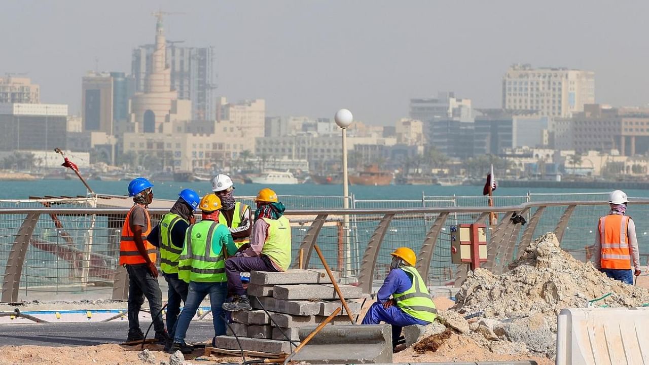 This file photo taken on May 21, 2022 shows workers fixing a sidewalk in the capital Doha, ahead of the Qatar 2022 FIFA World Cup. Credit: AFP Photo