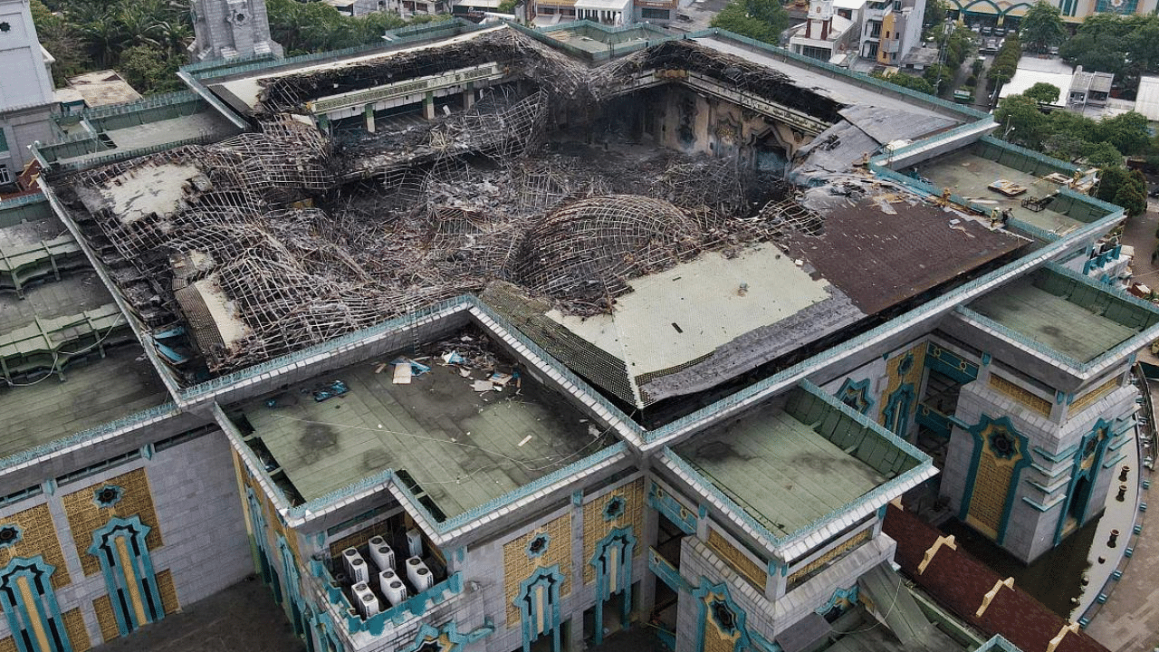 Aerial picture shows the smouldering remains of the collapsed dome of the Islamic Centre mosque in Jakarta. Credit: AFP Photo
