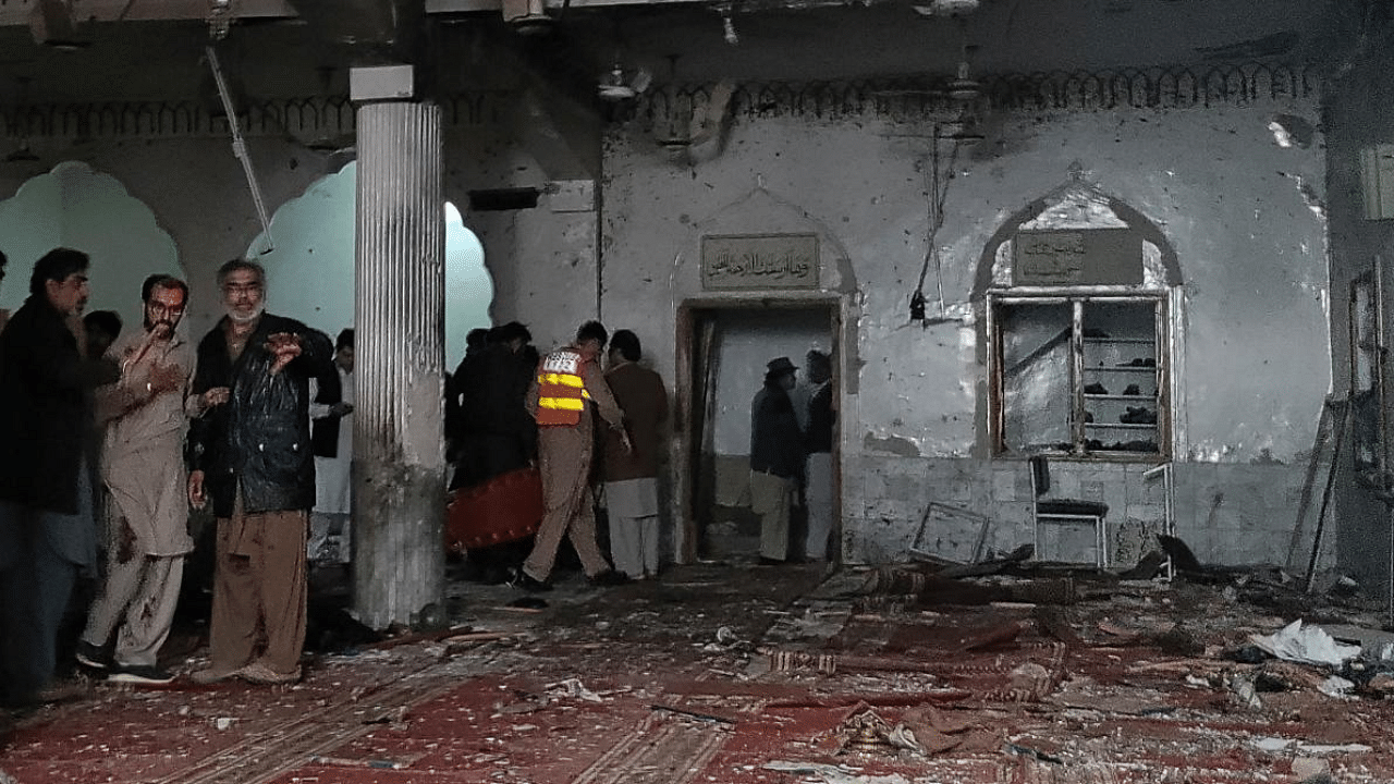 Officials inspect a a mosque after a bomb blast in Peshawar. Credit: AFP Photo