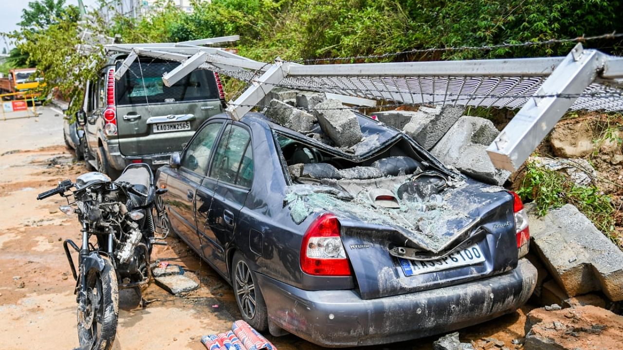 Parts of the mesh and wall had collapsed on several vehicles parked on the roadside. Credit: DH Photo