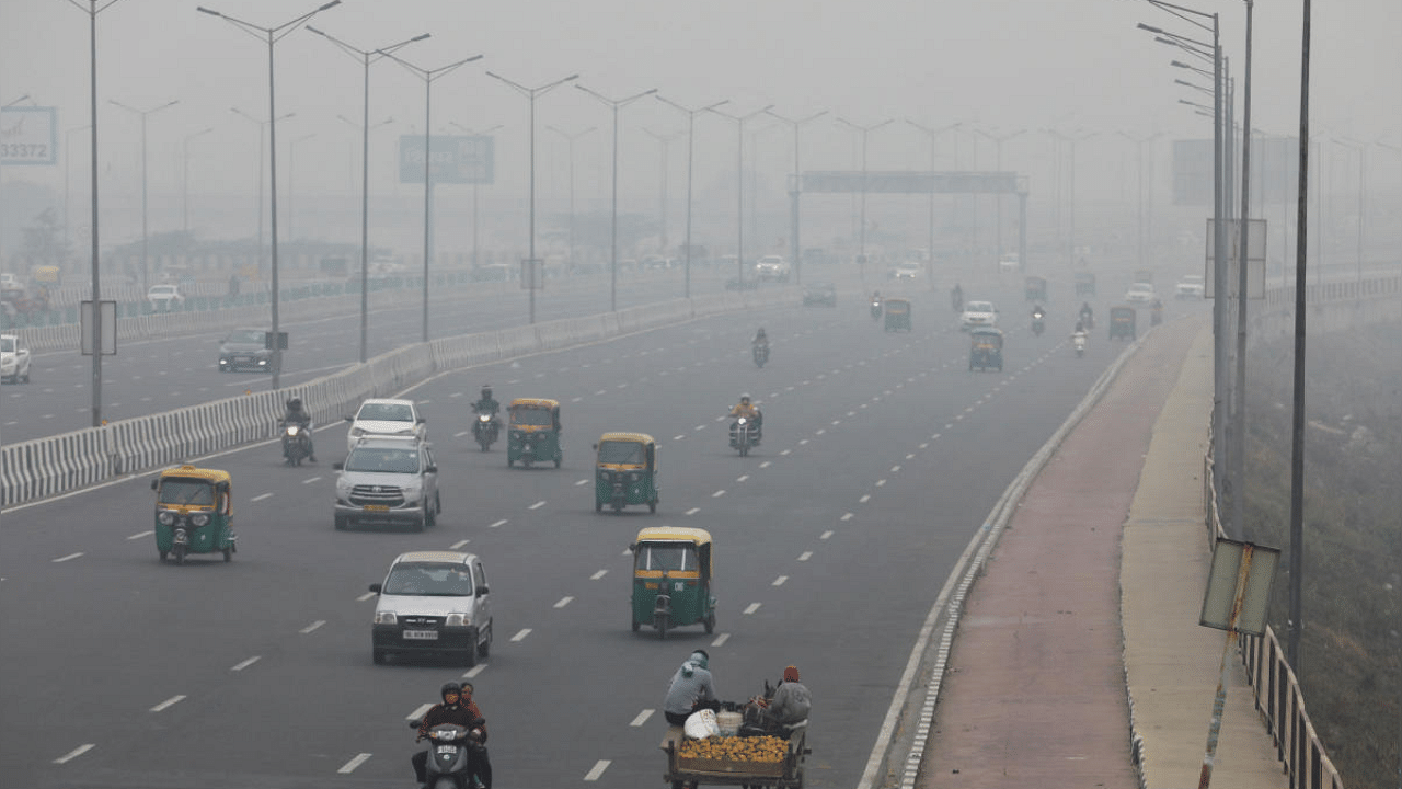 Vehicles are seen on a highway on a smoggy morning in Delhi. Credit: Reuters Photo