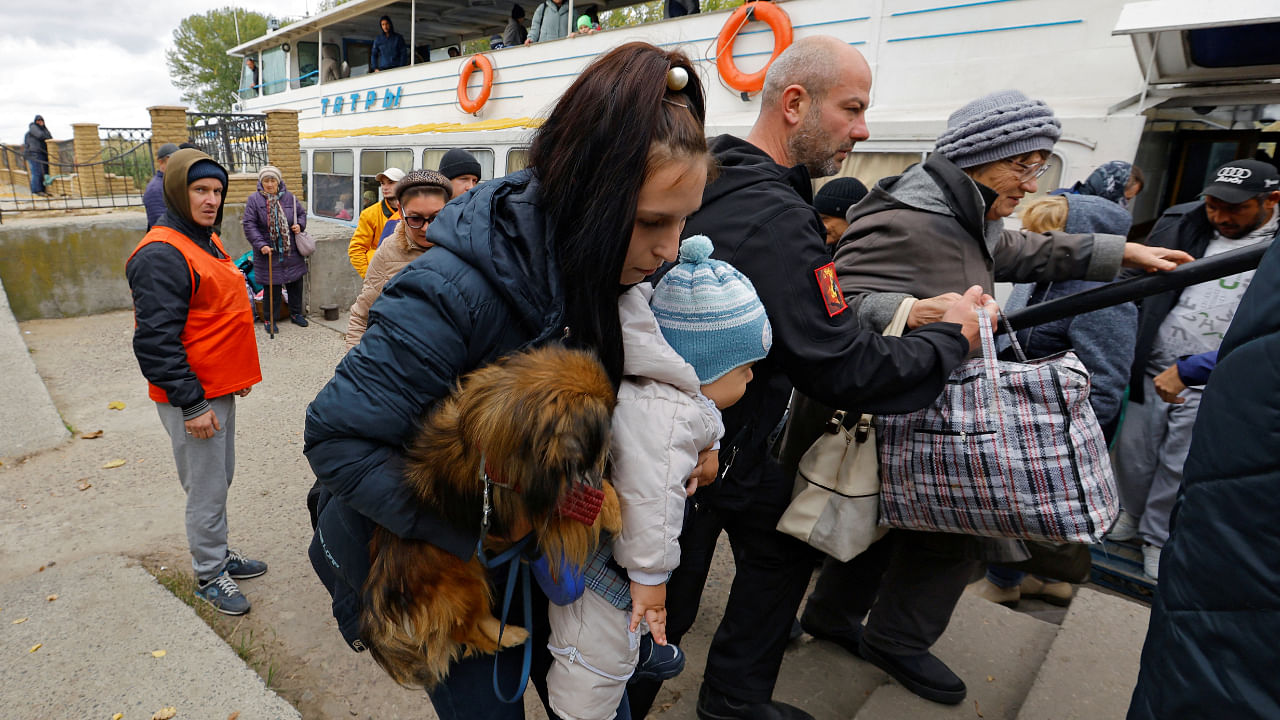 Civilians evacuated from the Russian-controlled city of Kherson disembark a ferry as they arrive in the town of Oleshky, Kherson region, Russian-controlled Ukraine. Credit: Reuters Photo