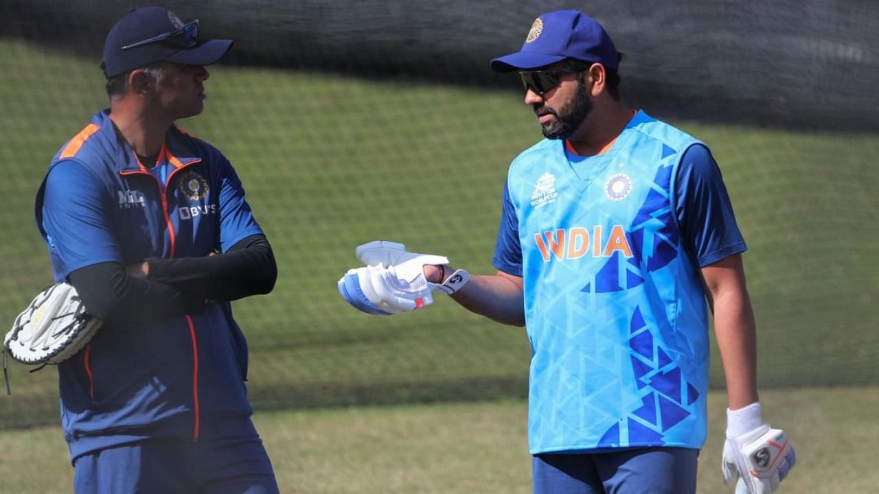 Indian skipper Rohit Sharma (R) speaks with head coach Rahul Dravid during a practice session at the MCG on Saturday. Credit: AFP Photo