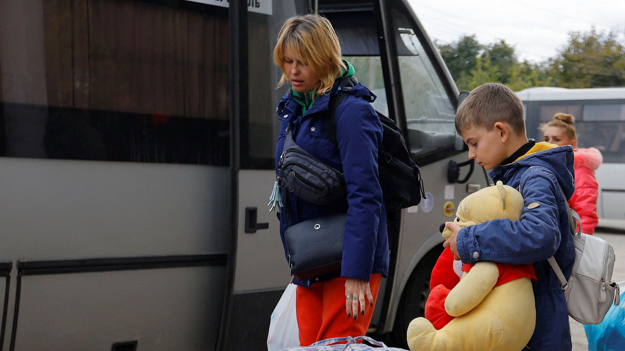 Civilians evacuated from the Russian-controlled city of Kherson wait to board a bus heading to Crimea, in the town of Oleshky, Kherson region, Russian-controlled Ukraine. Credit: Reuters Photo