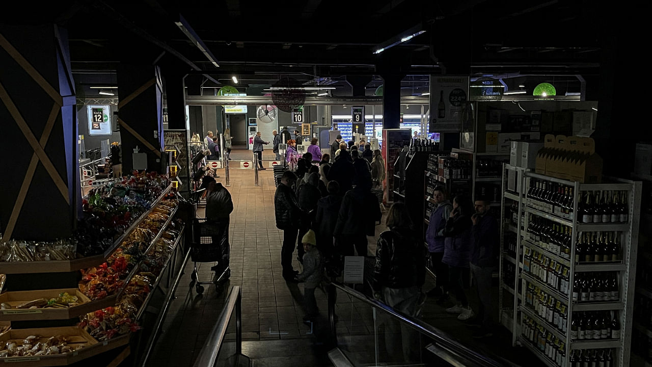 People visit in a supermarket without electricity, after a Russian missile attack, as Russia's invasion of Ukraine continues, in Kyiv, Ukraine October 22, 2022. Credit: Reuters Photo