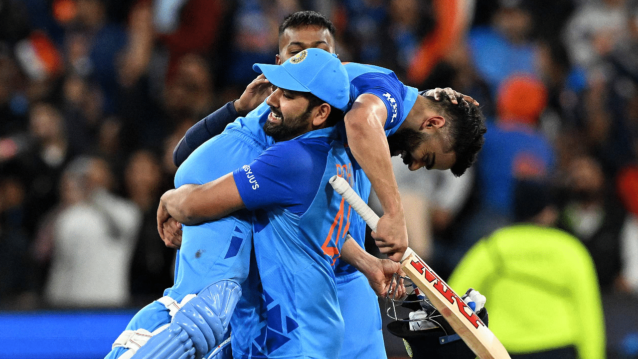 India's Captain Rohit Sharma (C) lifts Virat Kohli as they celebrate after a win during the ICC men's Twenty20 World Cup 2022 cricket match between India and Pakistan. Credit: AFP Photo