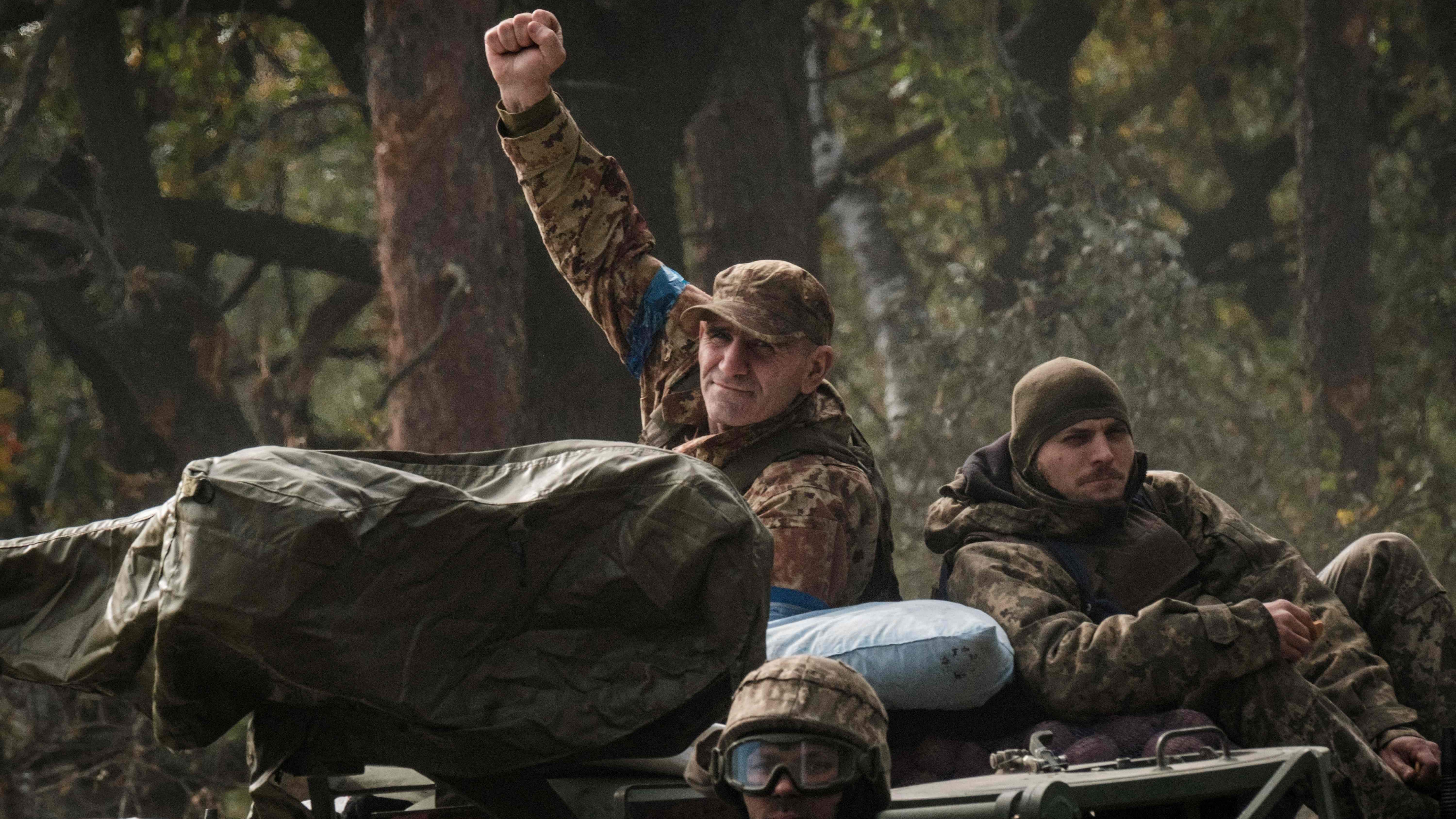 A Ukrainian soldier raise his fist on an armoured vehicle near the recently retaken town of Lyman in Donetsk region. Credit: AFP Photo