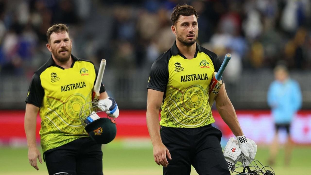 Australia's Aaron Finch (L) and Marcus Stoinis walk off the field after their win in the ICC men's Twenty20 World Cup 2022 cricket match between Australia and Sri Lanka at Perth Stadium. Credit: AFP Photo