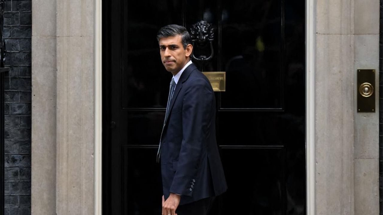 UK Prime Minister Rishi Sunak poses outside the door to 10 Downing Street in London. Credit: AFP Photo
