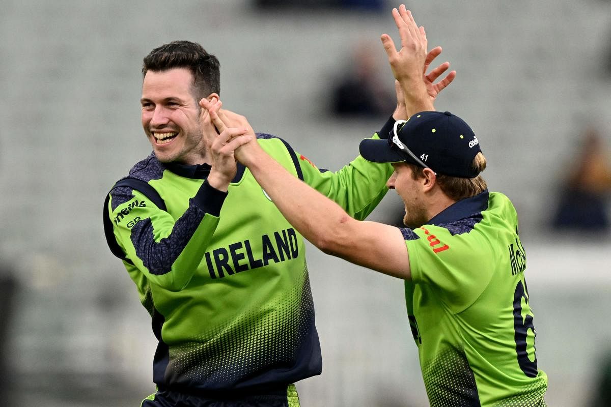Ireland's George Dockrell (L) celebrates his wicket of England's Harry Brook with teammate Ireland's Barry McCarthy during the ICC men's Twenty20 World Cup 2022 cricket match between England and Ireland at Melbourne Cricket Ground (MCG) on October 26, 2022 in Melbourne. Credit: AFP Photo