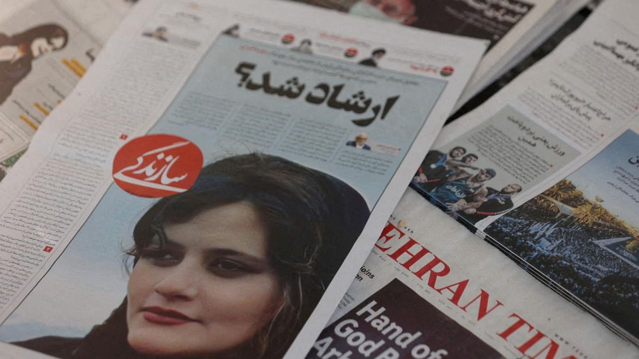 A newspaper with a cover picture of Mahsa Amini, a woman who died after being arrested by Iranian morality police. Credit: Reuters File Photo