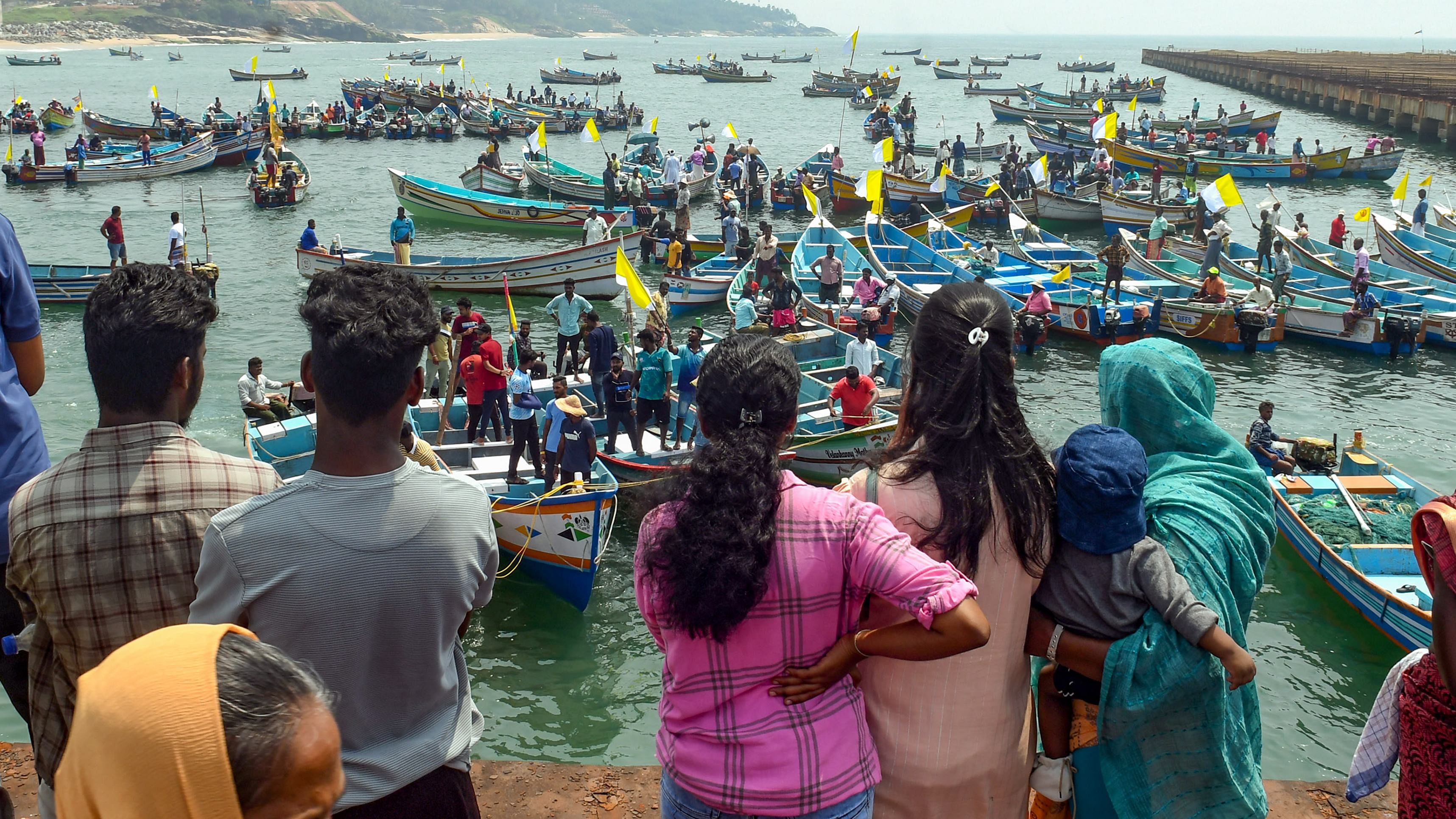 Hundreds of fisherfolk, including women, reached the area via road and sea and broke open the lock of the gate of the project site, raising slogans. Credit: PTI Photo