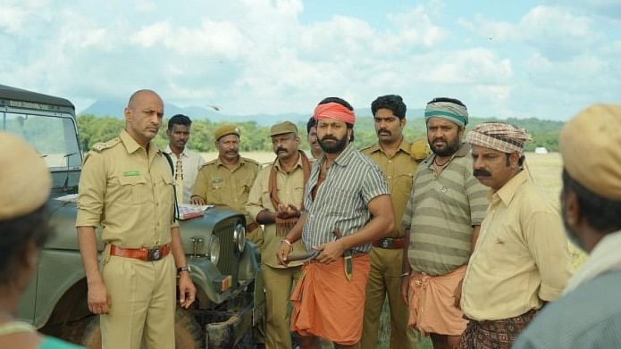 In ‘Kantara’, Rishab Shetty plays a rebellious a localite, who is always at loggerheads with a forest officer, essayed by Kishore. Credit: Screengrab from the movie