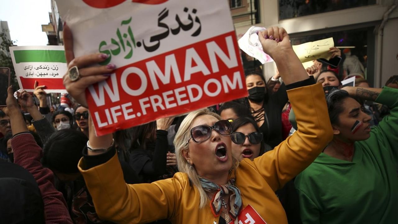 Iranian women shout slogans to protest over the death of Mahsa Amini during a demonstration. Credit: AP/PTI Photo