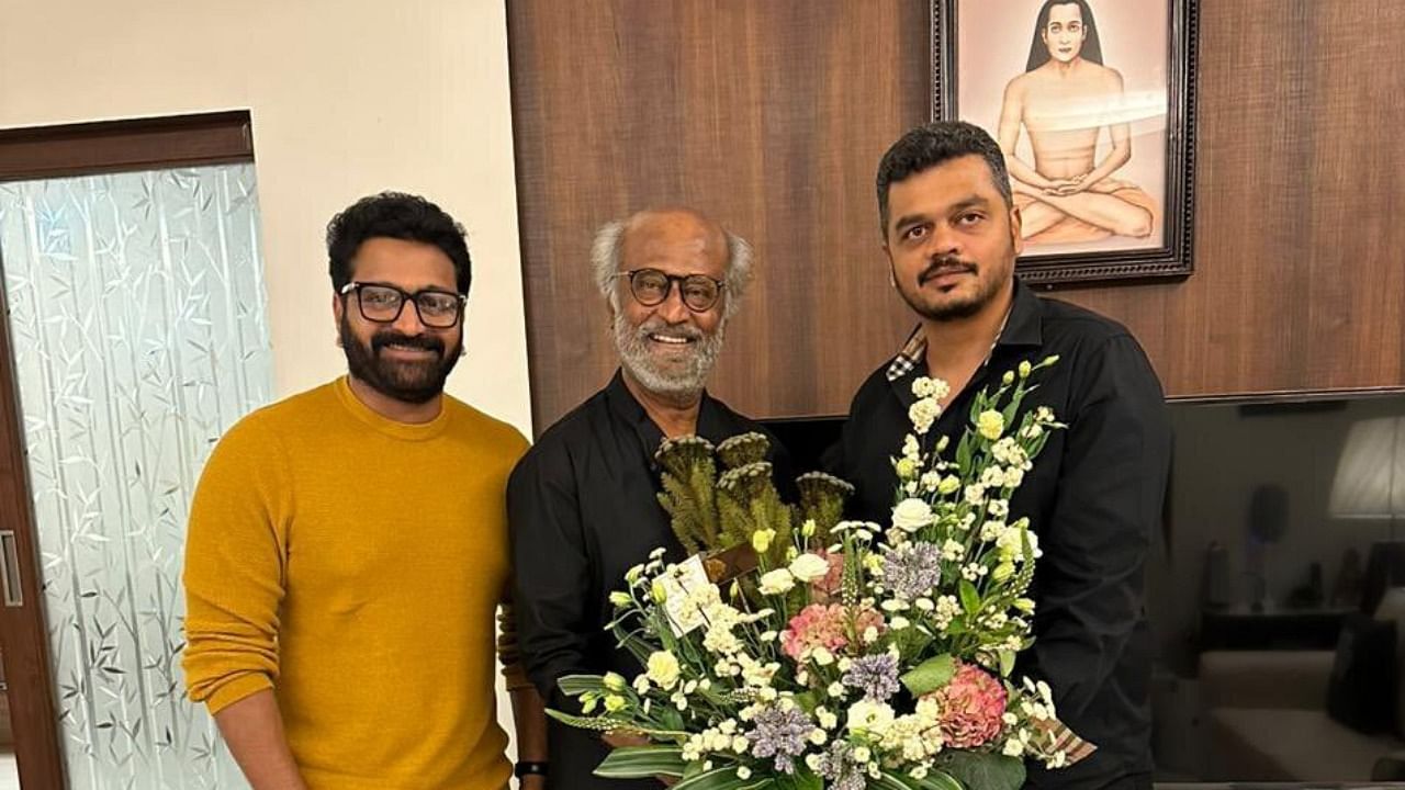 Superstar Rajinikanth with actor-writer Rishab Shetty and producer Karthik Gowda of 'Kantara' fame. Credit: Twitter / @hombalefilms