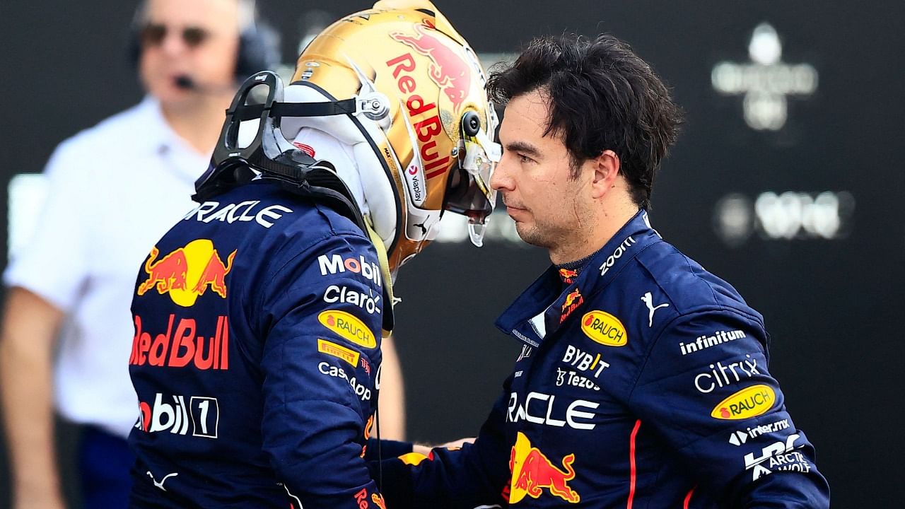 Red Bull Racing's Dutch driver Max Verstappen (L) is greeted by his teammate Mexican driver Sergio Perez after taking the pole position in the Formula One Mexico Grand Prix. Credit: AFP Photo