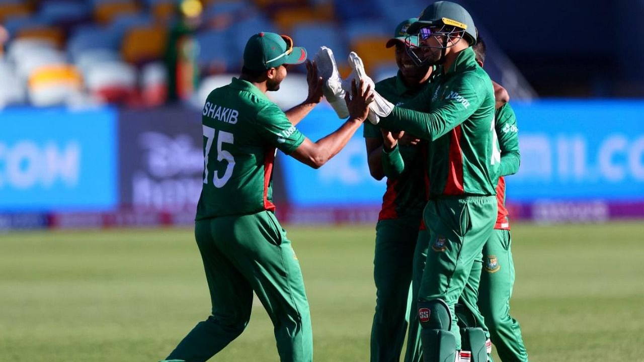 Bangladesh skipper Shakib Al Hasan (L) celebrates with teammates at the T20 World Cup match with Zimbabwe. Credit: AFP Photo