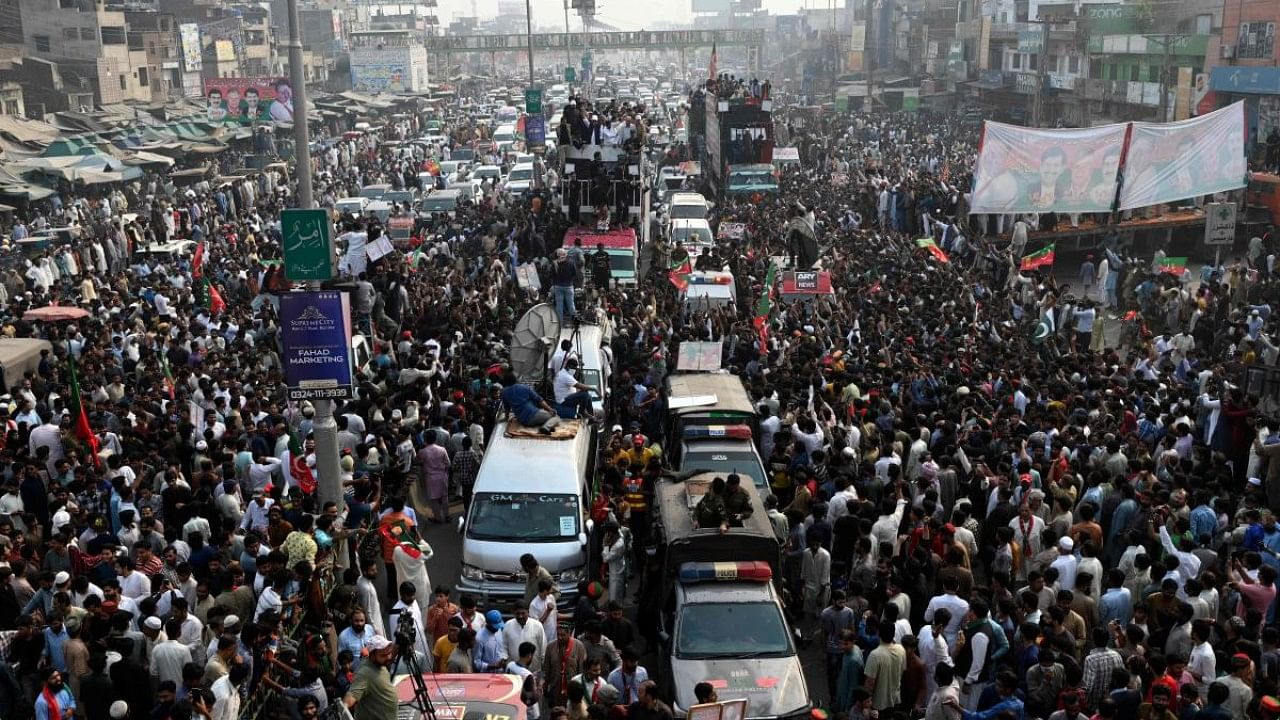 Pakistan's former prime minister Imran Khan (C, on truck) along with his party leaders take part in an anti-government march towards Islamabad city, demanding early elections. Credit: AFP Photo