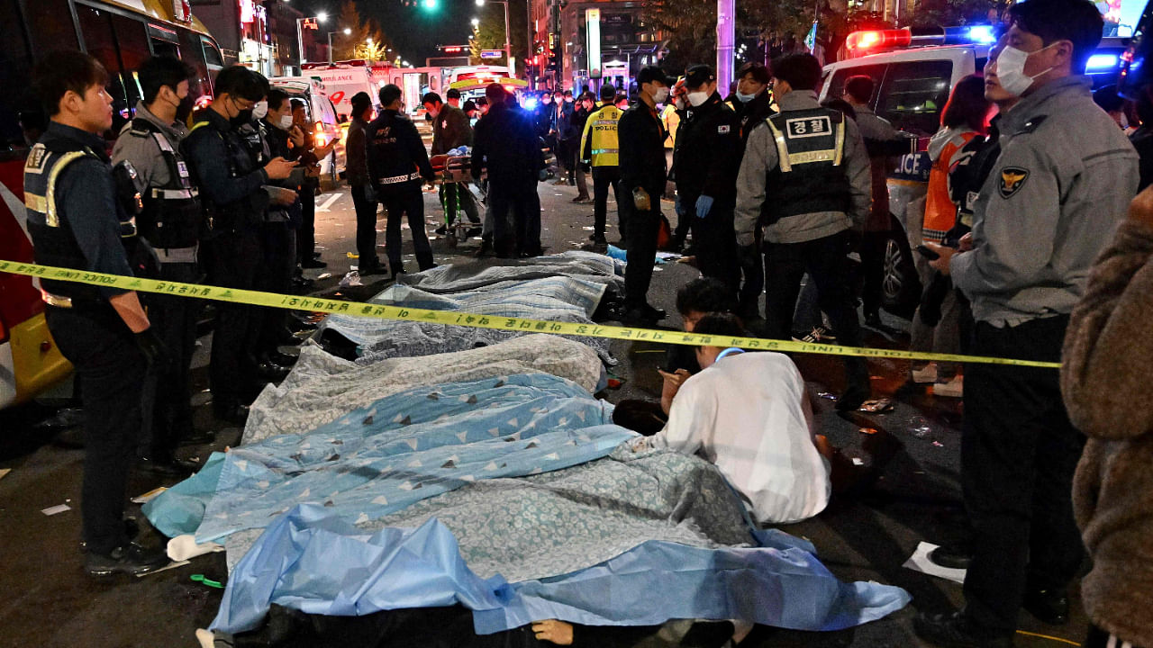 The bodies of victims, who were killed in a Halloween crush, are covered with sheets in the neighbourhood of Itaewon in Seoul. Credit: AFP Photo