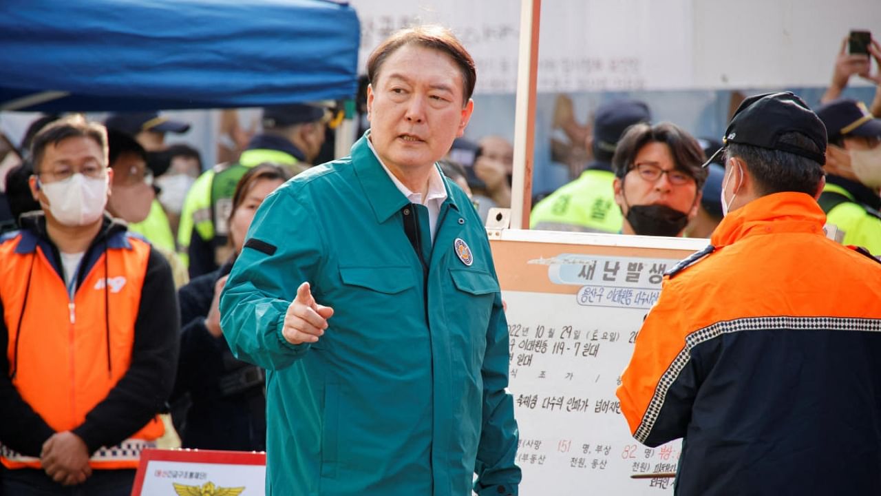 South Korean President Yoon Suk-yeol walks towards the scene where many people died and were injured in a stampede during a Halloween festival in Seoul, South Korea. Credit: Reuters Photo