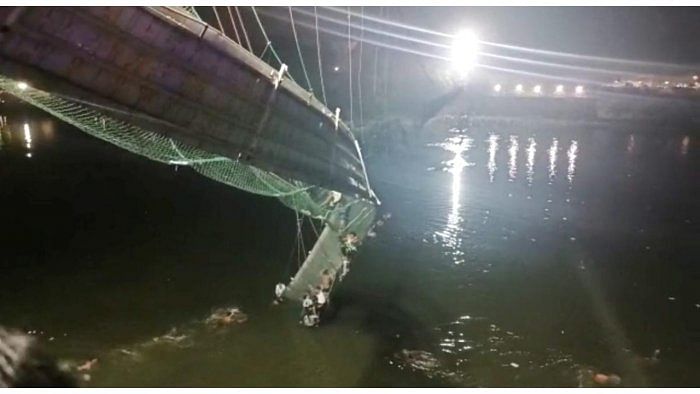 Rescue operation under way after an old suspension bridge over the Machchhu river collapsed, in Morbi district. Credit: Reuters photo